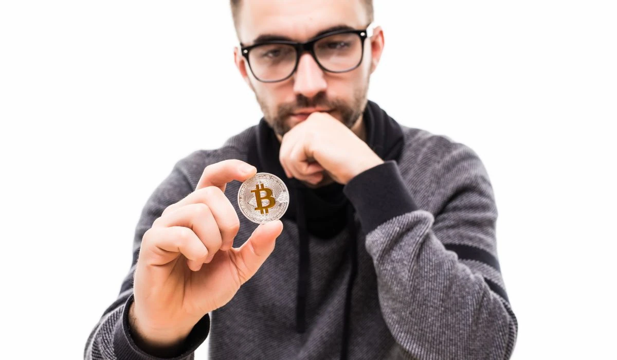 A young man thinking about Bitcoin.