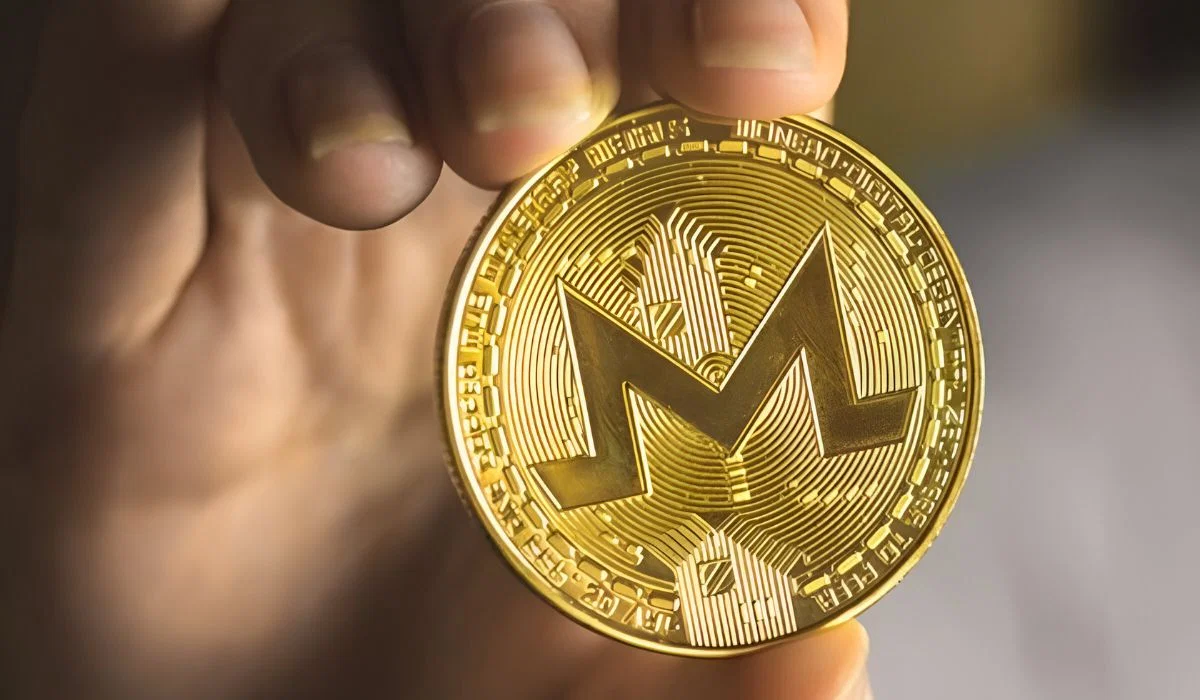 Person Holding Monero (XMR)